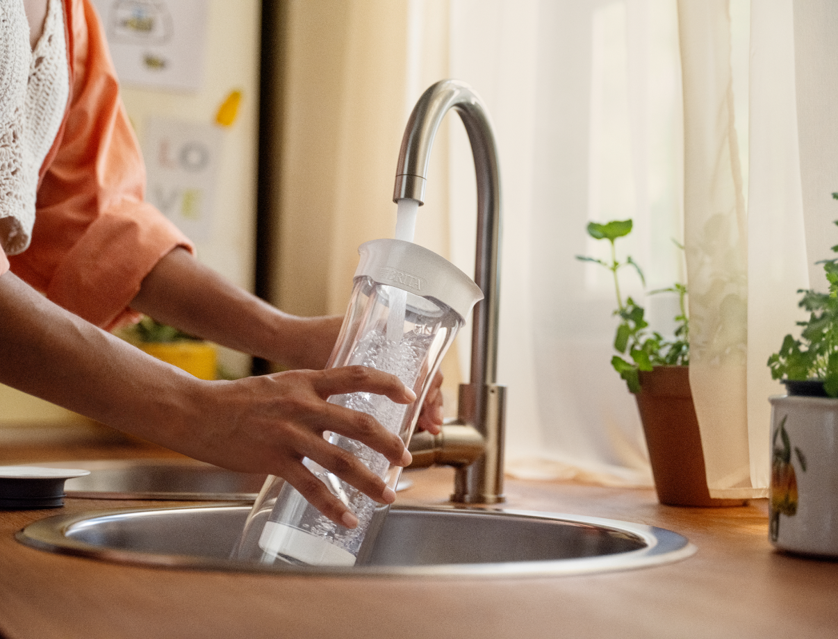 Brita water filter carafe being refilled