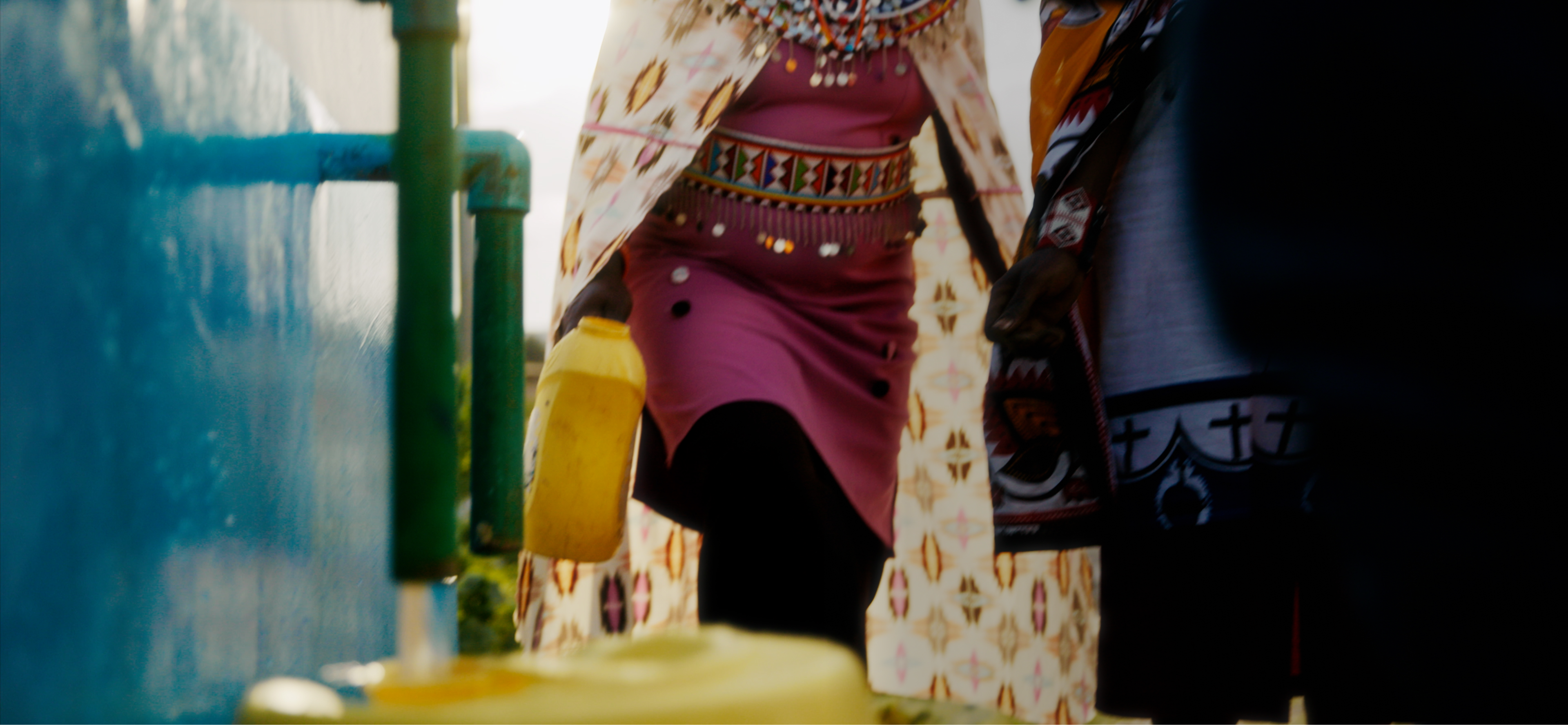 People filling up canisters of water at public collection point