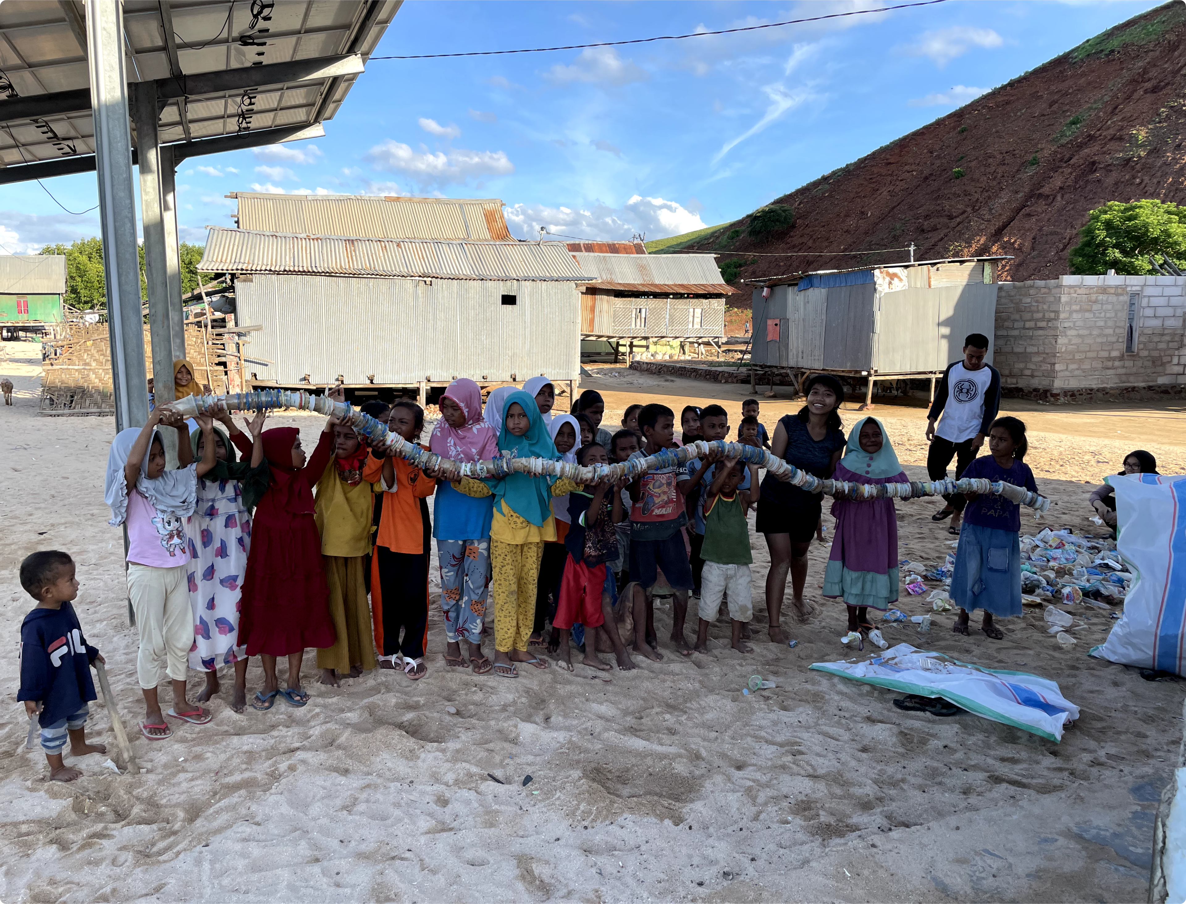 Children presenting their collected cups for recycling