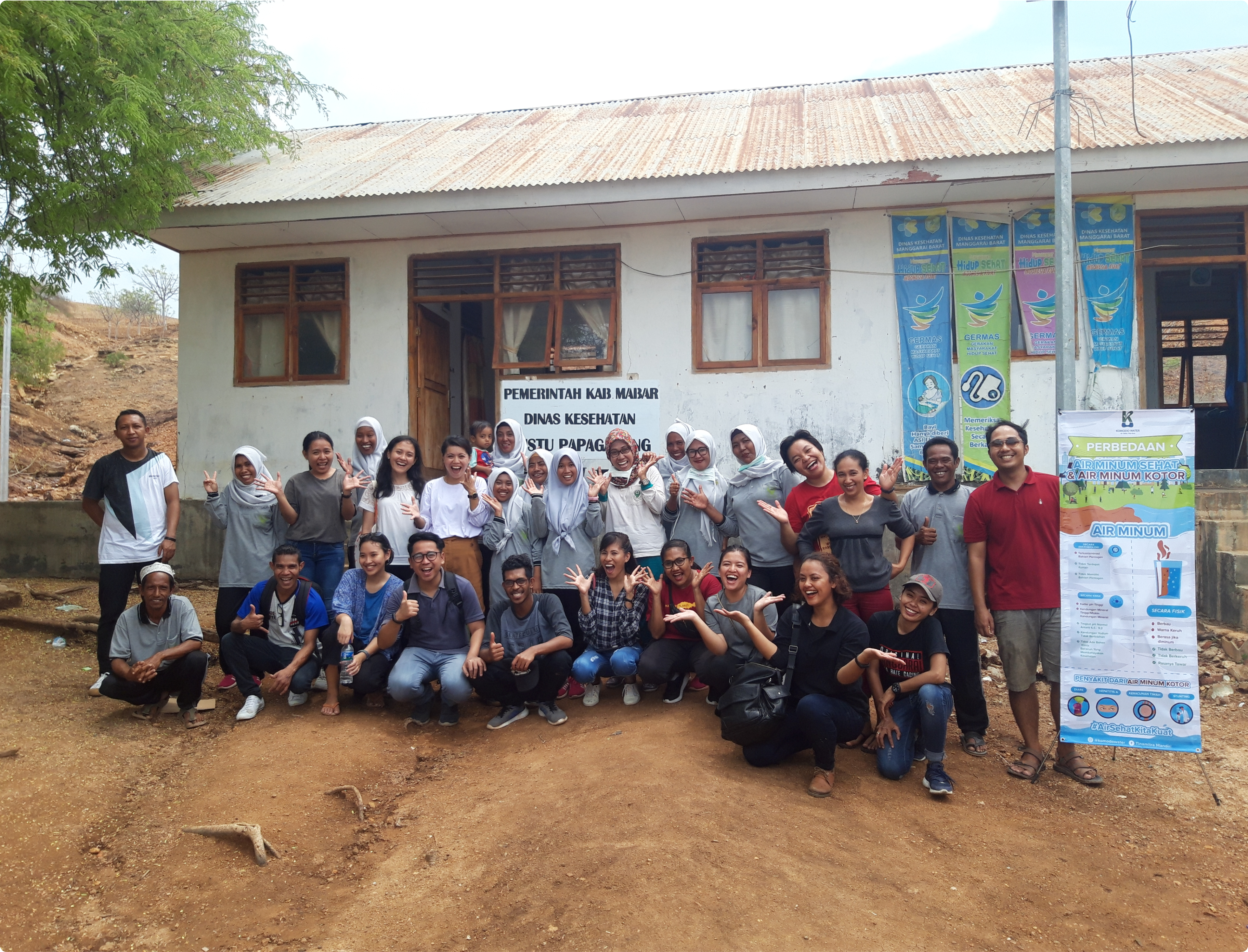 Group poses in front of local community center