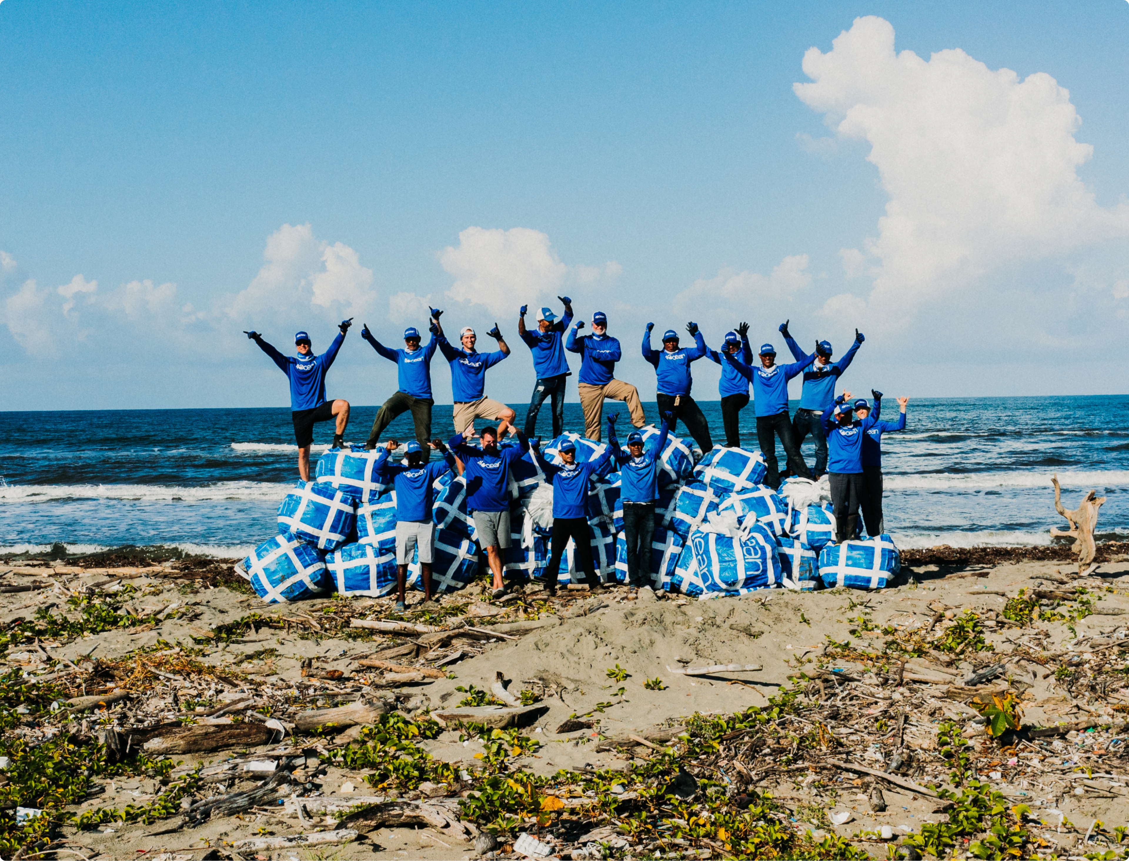 Group picture of 4ocean volunteers and the trash they have collected.